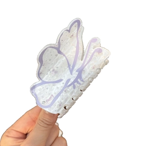 Chic butterfly acrylic hair claw with floral pattern and rhinestone detail in purple and white