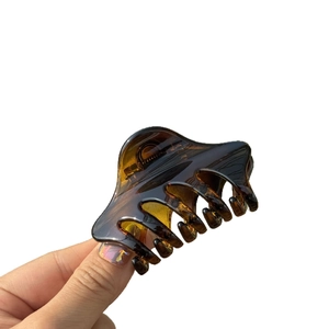 Elegant amber tortoise shell hair claw clip with minimalist butterfly buckle design