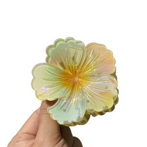 Iridescent flower hair claw clip with colorful gradient for high ponytail styling