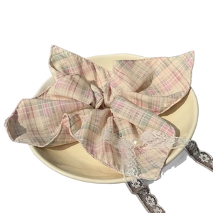 Pastel plaid lace bow scrunchie with pearl detail in a decorative yellow tray