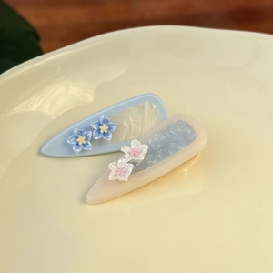 Teardrop acetate flower hair clips in blue and beige with elegant marble patterns