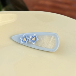 Pale blue teardrop hair clip with elegant acetate flowers and marble texture insert