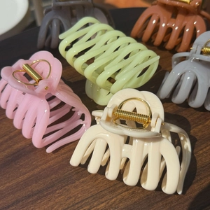 French style cream pumpkin hair claws set in multiple matte colors on a wooden background