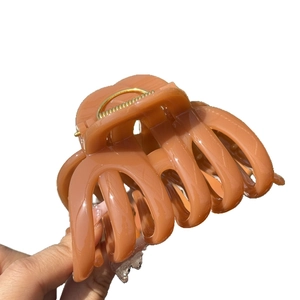 Elegant large amber pumpkin hair claw clip with strong gold metal spring for thick hair