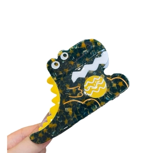 Pince à cheveux en acétate écaille de tortue avec un joli motif de dinosaure jaune