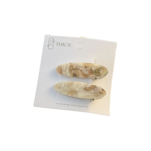 Set of two marble pattern acetate oval hair clips with gold lettering on display card