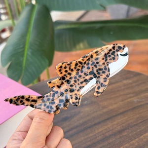 Close-up of leopard print tuna shaped hair claw clip made of acetate fiber