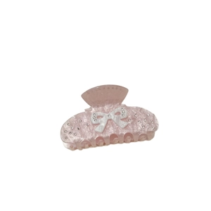 Pink acrylic hair claw clip with white bow and sparkling rhinestones for women