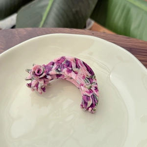 Floral acetate hair claw clip with a rose design and colorful marble pattern finish