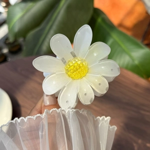 Detailansicht einer weißen Gänseblümchen-Haarklammer mit gelber Mitte und Blüten