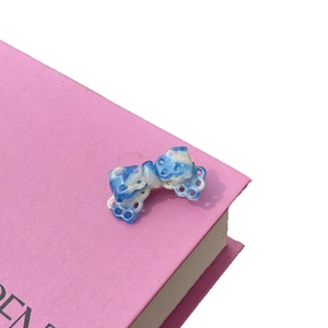 Mini acetate bow hair clip with blue and white marble pattern and hollow lace design
