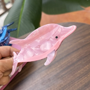 Pink acetate dolphin hair claw clip for women featuring a pearlescent finish