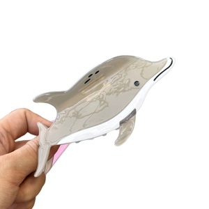 Dolphin shaped acetate hair claw clip with brown marble pattern and white color block
