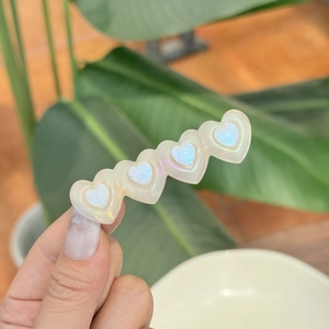 Sweet heart-shaped hair clip with iridescent glitter and colorful floral pattern