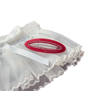Elegant red oval hollow hair clip with pink rhinestones on white lace background
