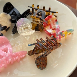 Macro detail of high-quality acetate hair clips with strong gold metal springs