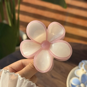 Pink and white jelly-colored flower hair claw clip with a glossy translucent finish