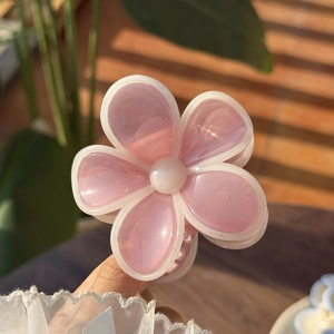 Detailed view of pink translucent jelly flower hair claw clip with white borders