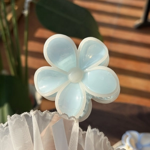 Detailed view of sweet blue jelly flower hair claw clip with white edges and matte finish