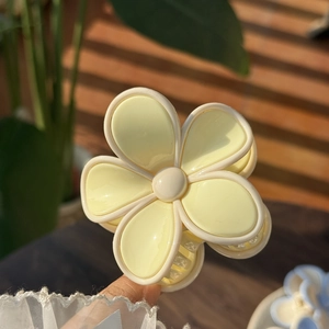 Close-up of a sweet yellow jelly flower hair claw clip with a glossy resin finish