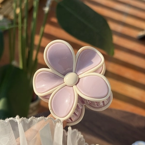 Detail view of sweet jelly pink floral hair claw clip with cream borders and resin finish