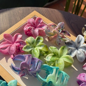 Dettaglio di fermagli per capelli a forma di fiore con pittura a inchiostro colorato