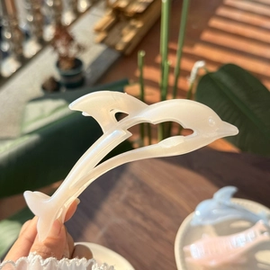 Elegant pearl white dolphin hair claw clip with a glossy shell finish and ocean style design