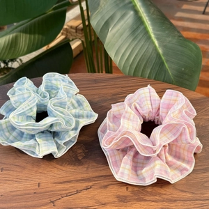 Floral plaid fabric scrunchie set in pastel blue and pink on wooden display