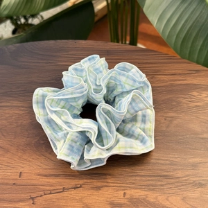 Chic blue and green plaid scrunchie in premium fabric for a fresh spring hairstyle
