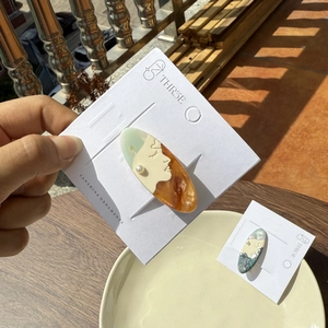 Artistic acetate hair clip with vintage profile and pearl on a display card
