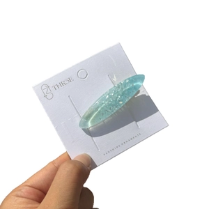 Barrette à cheveux ovale en résine bleu clair pailleté avec éclats d'argent
