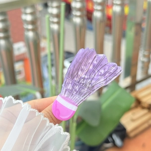 Detail of a purple acrylic badminton shuttlecock hair clip with a translucent finish