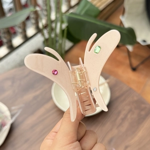Elegant butterfly hair claw clip in pink glitter acetate with colorful rhinestones decoration