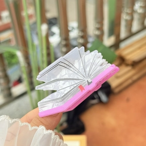 Unique book shaped acrylic hair claw clip with pearlescent white texture and pink base