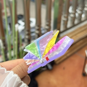 Artistic book-shaped acrylic hair claw clip with colorful marble pearlescent textures