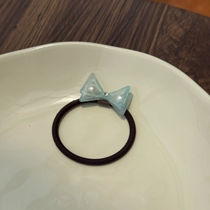 Double-layered blue bow hair tie with pearls and crystals for high ponytail styling