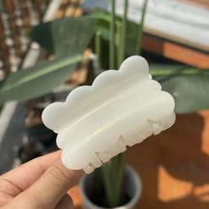 Sparkly white translucent cookie-shaped hair claw clip with a wave-edge design