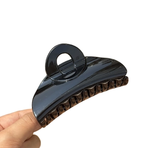 Minimalist large black glossy shark hair clip for women with a sleek mirror finish surface