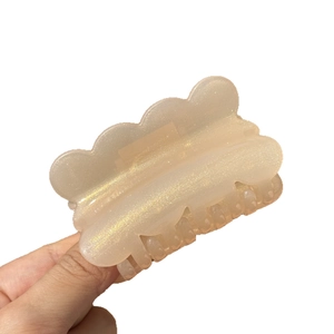 Sparkling resin hair claw clip in champagne beige with glitter finish and wavy edge design