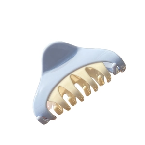 Minimalist triangular two-tone hair claw clip in matte light blue and cream white color