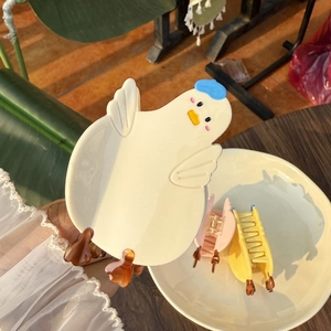 Cute cartoon chick hair claws in cream, pink, and yellow colors with blue hat accents