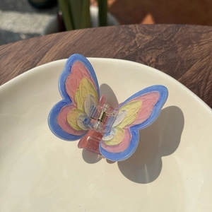 Artistic acrylic butterfly hair claw with colorful hand-painted wing patterns for women