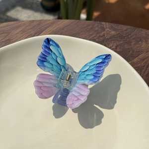 Elegant acrylic butterfly hair claw with blue and purple gradient and ink texture