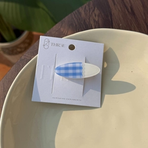 Sweet oval plaid hair clip with blue fabric texture and lace detail on a card