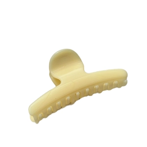French cream yellow resin hair claw clip for women featuring a glossy pumpkin style finish