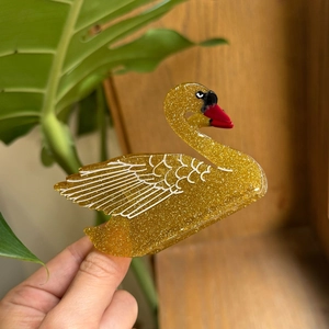 Molla per capelli a forma di cigno dorato scintillante con piume bianche e becco rosso