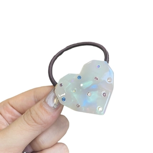 Cute iridescent heart-shaped hair tie with colorful rhinestones on purple elastic rope