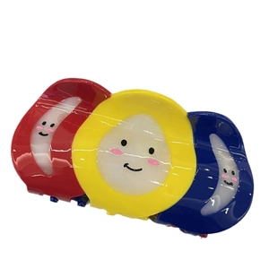 Set of three colorful acetic acid hair claws with smiley faces in red yellow and blue