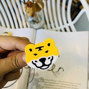 Macro view of cute tiger acetate hair clip with thick yellow resin and black details