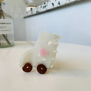 Chic roller skate hair claw clip in pearlescent acetate with pink heart detail